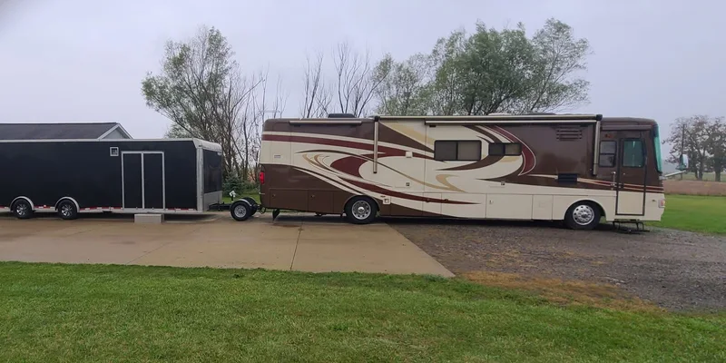 Class A motorhome towing an enclosed car hauler with a Trailer Toad