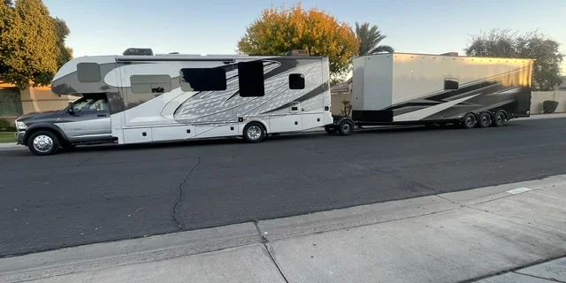 Super C motorhome towing a toy hauler with a Trailer Toad